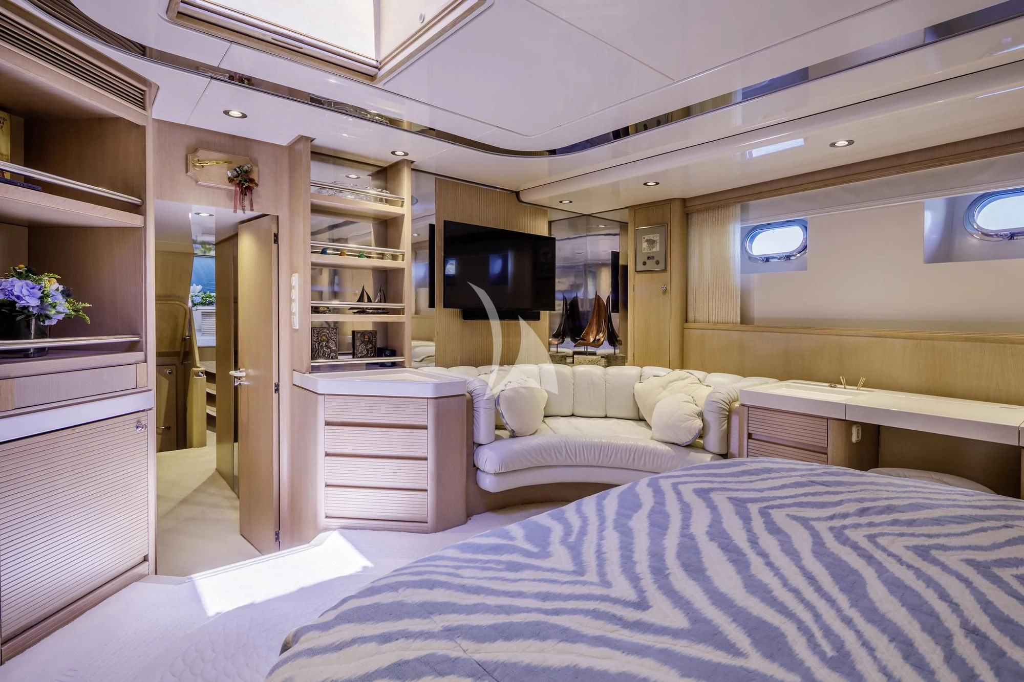 a bedroom with a bed and a tv aboard NOMMO Yacht for Sale
