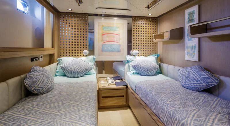 a room with two beds aboard NOMMO Yacht for Sale