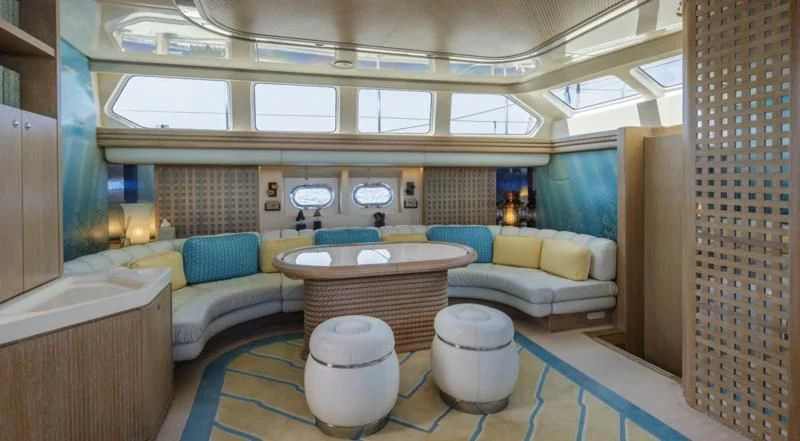 a room with a table and chairs aboard NOMMO Yacht for Sale