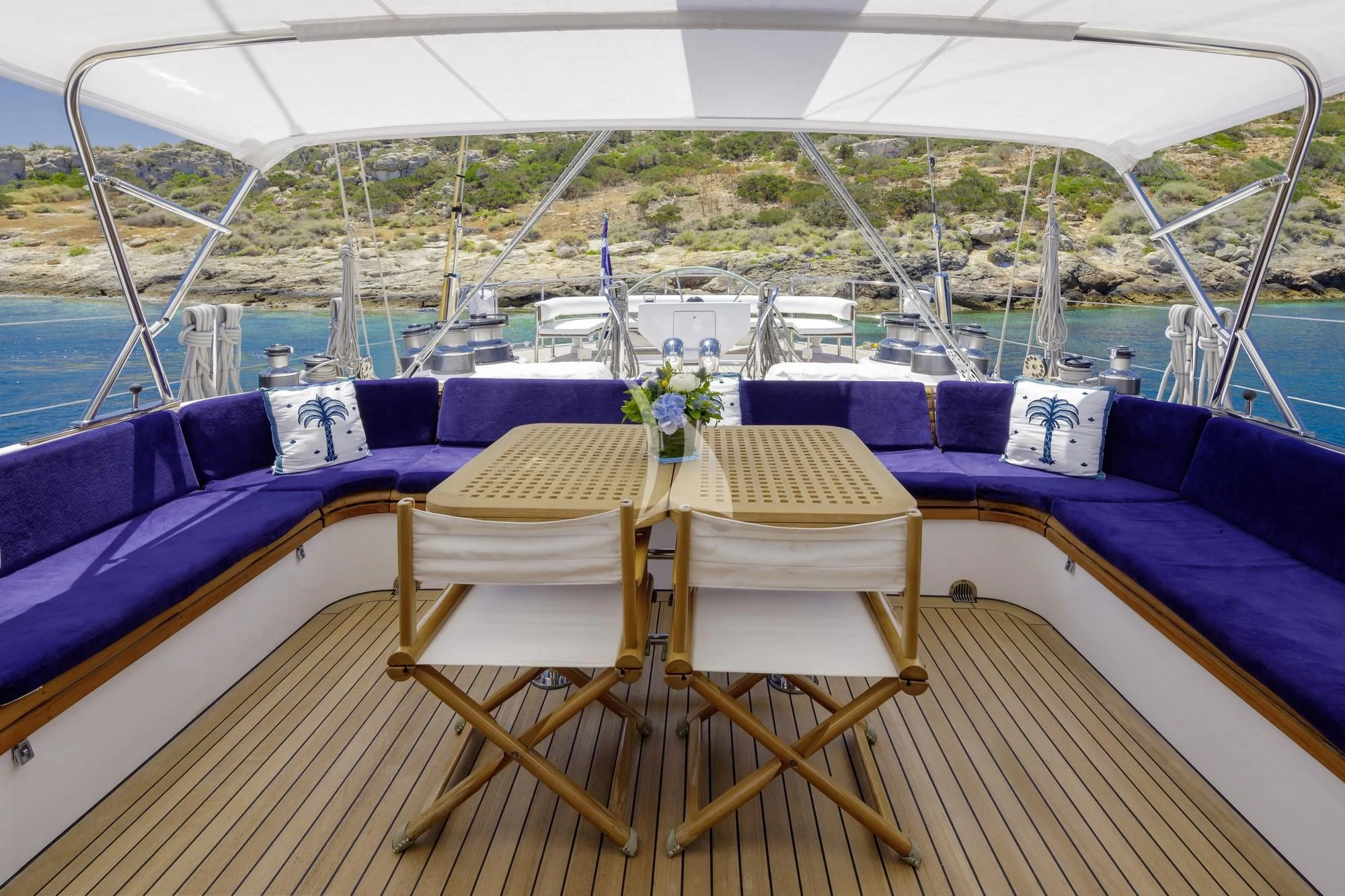 a table and chairs on a boat aboard NOMMO Yacht for Sale