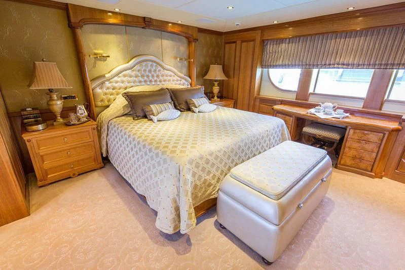 a bedroom with a bed and a desk aboard VITA NOVA Yacht for Sale