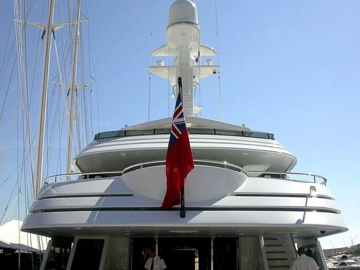 a large white boat with a flag on it aboard VITA NOVA Yacht for Sale