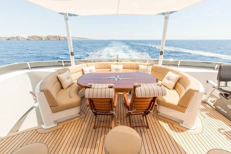 a table set for a meal on a deck overlooking the ocean aboard VITA NOVA Yacht for Sale