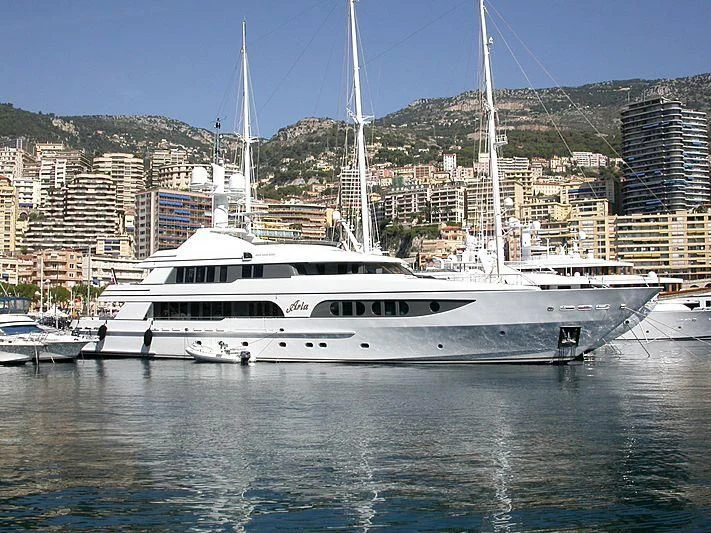 a white yacht in a harbor aboard VITA NOVA Yacht for Sale