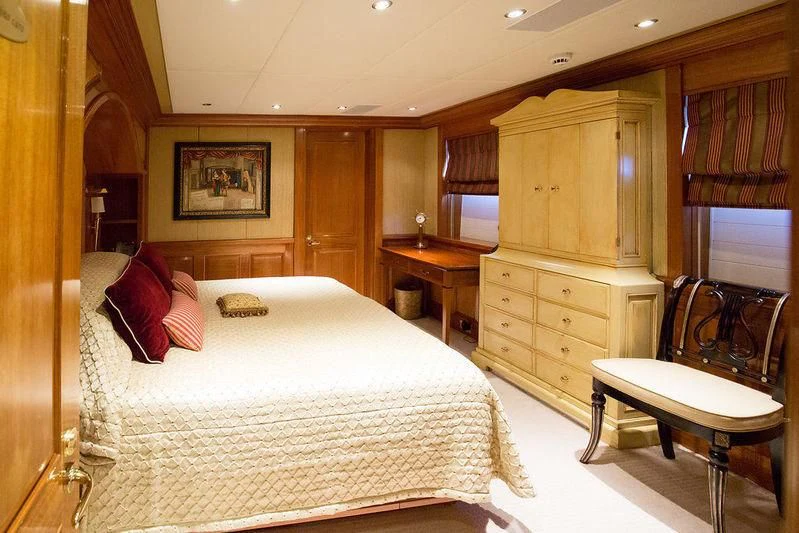 a bedroom with a bed and desk aboard VITA NOVA Yacht for Sale