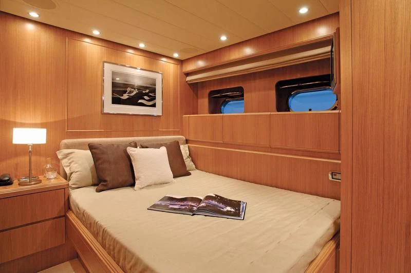 a bed with a white bed spread aboard SERALIN Yacht for Sale