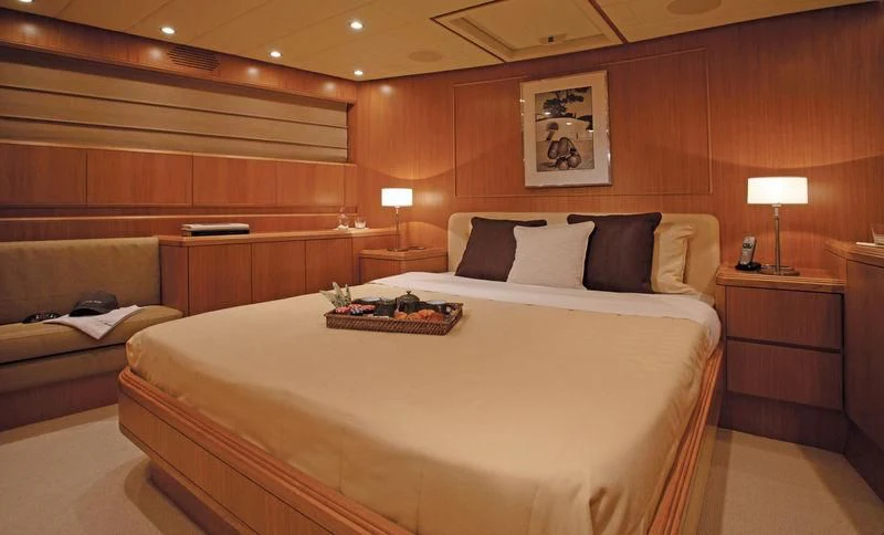 a room with a bed and a table aboard SERALIN Yacht for Sale