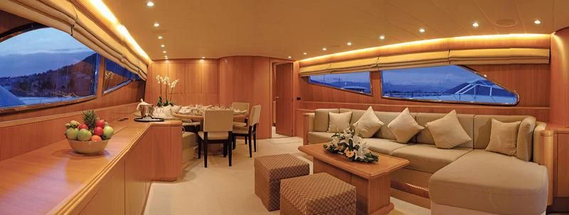 a room with a couch and a table and a television aboard SERALIN Yacht for Sale