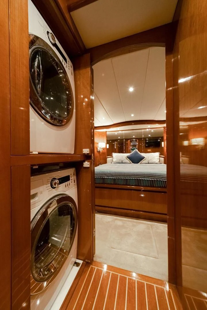 a room with a bed and a mirror aboard DREAM CATCHER Yacht for Sale