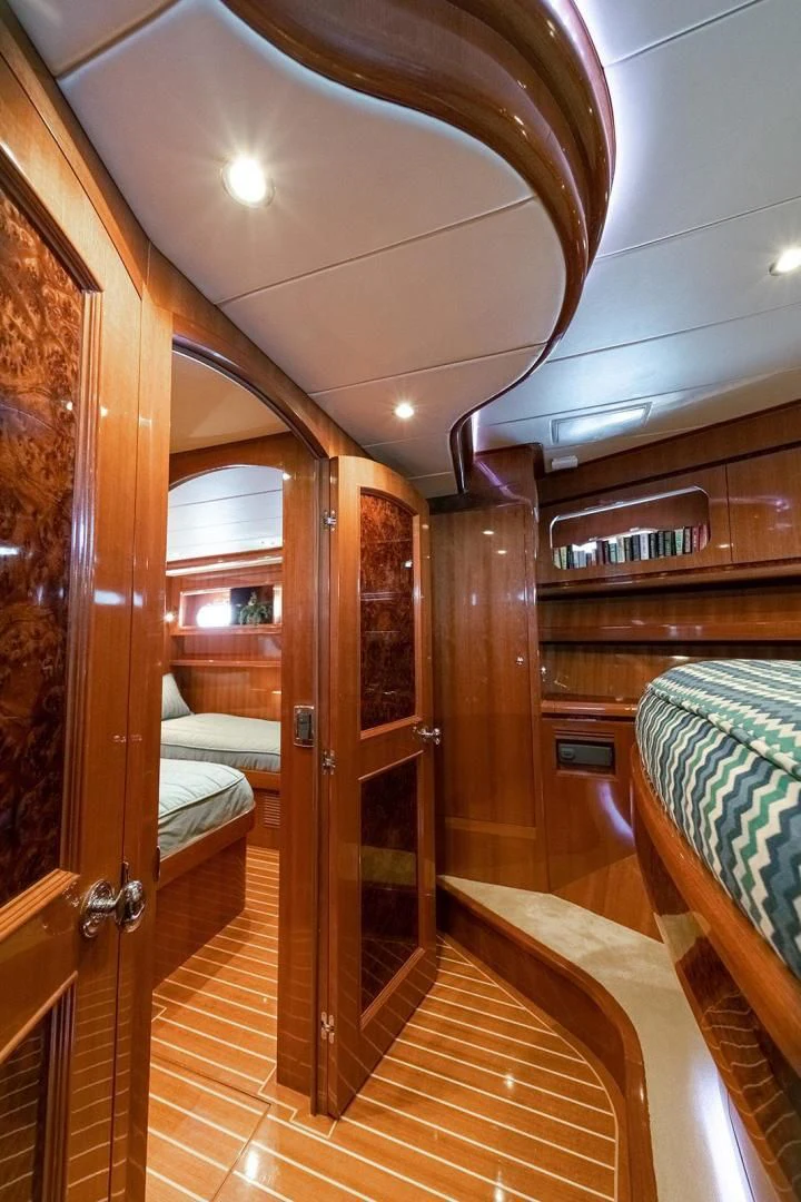 a room with a wood door and a bed aboard DREAM CATCHER Yacht for Sale