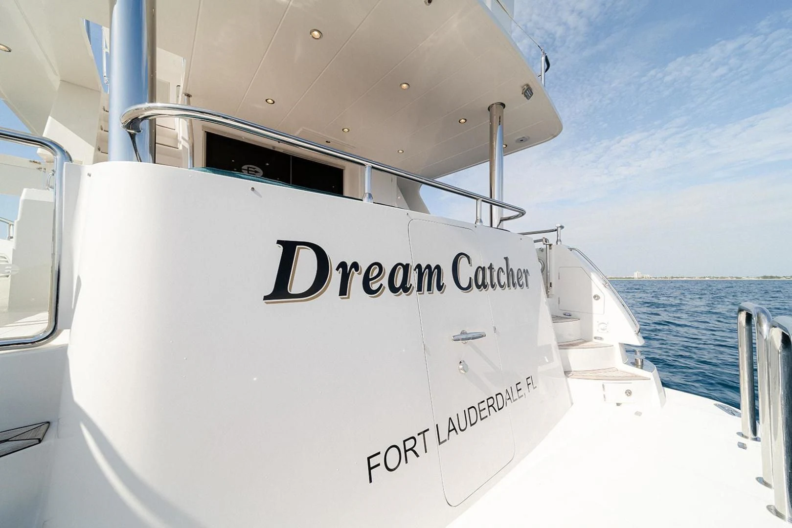 a white boat on a body of water aboard DREAM CATCHER Yacht for Sale