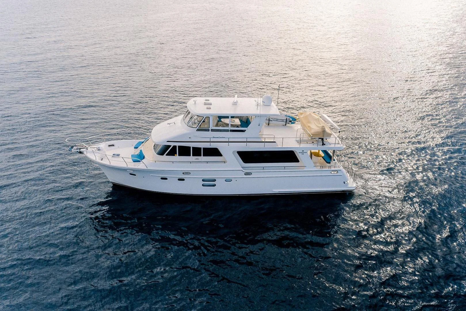a white boat in the water aboard DREAM CATCHER Yacht for Sale