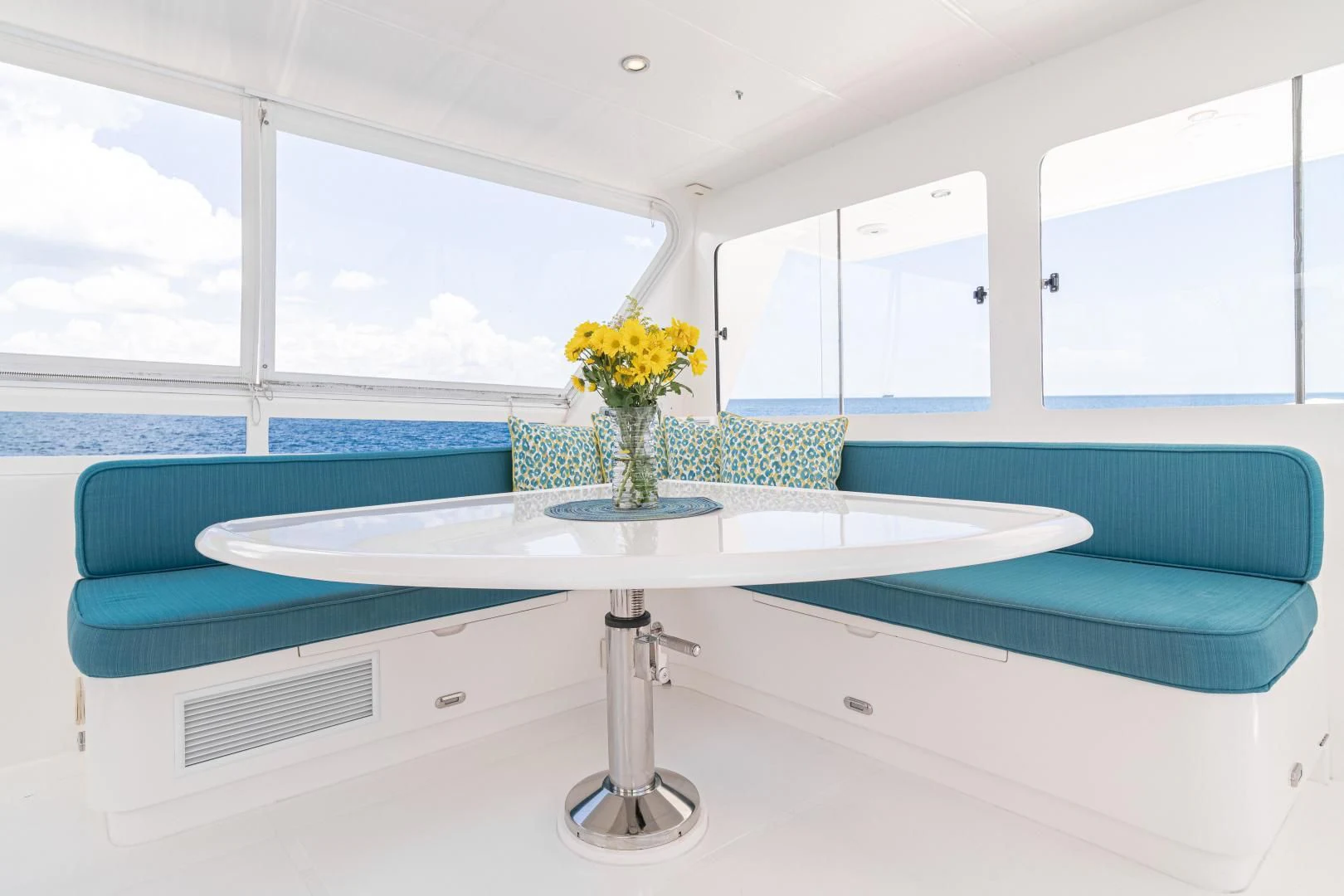 a vase of yellow flowers on a table aboard DREAM CATCHER Yacht for Sale