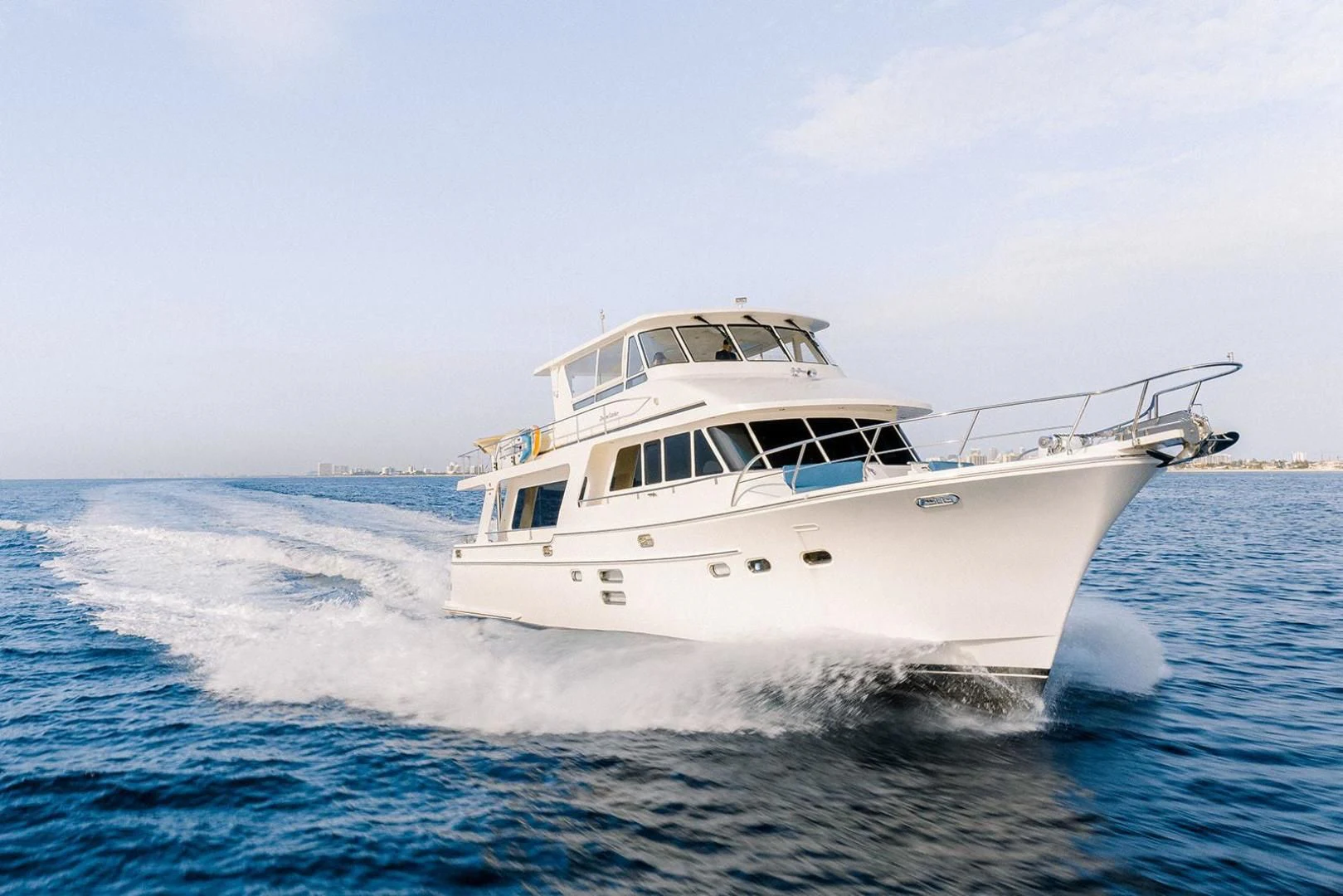 a white boat on the water aboard DREAM CATCHER Yacht for Sale
