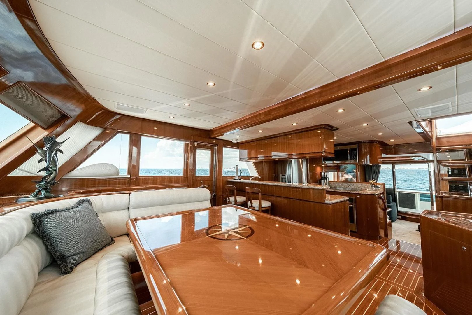 a large room with a table and couches aboard DREAM CATCHER Yacht for Sale