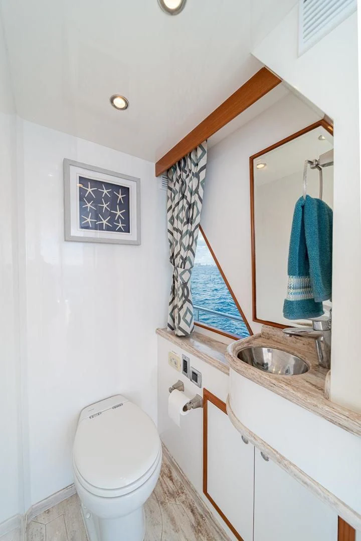 a bathroom with a toilet and sink aboard DREAM CATCHER Yacht for Sale