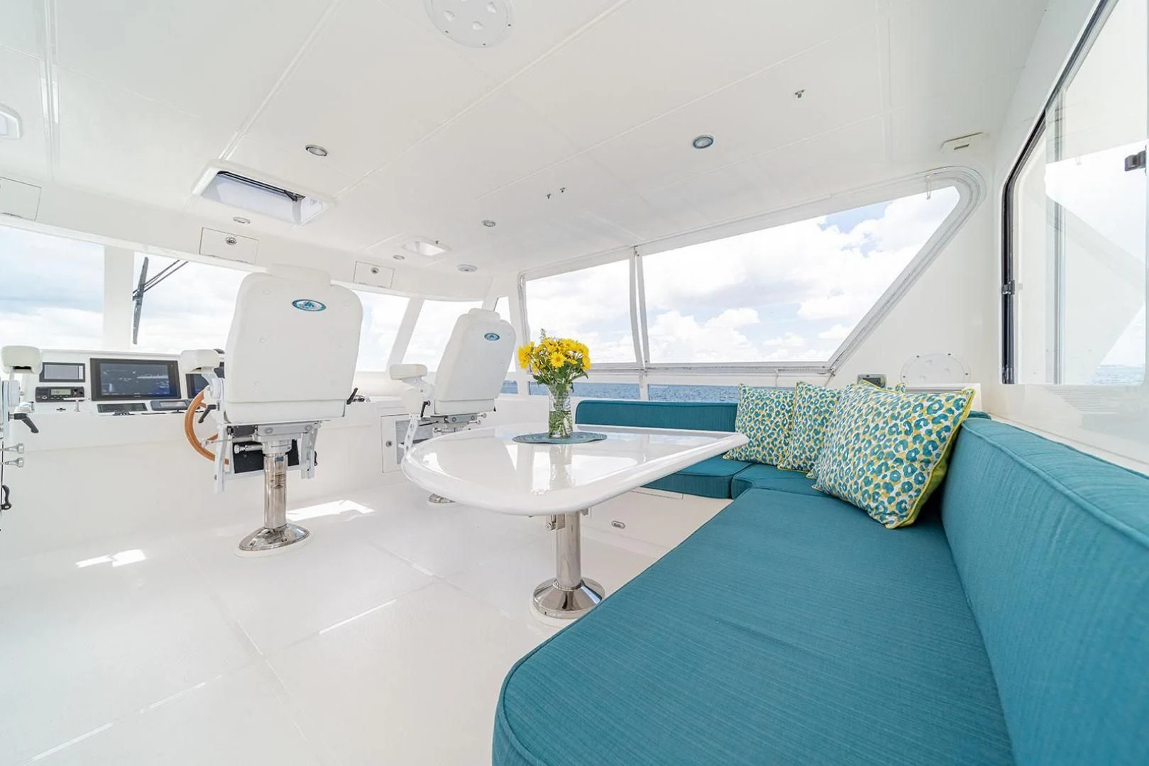 a room with a table and a couch aboard DREAM CATCHER Yacht for Sale