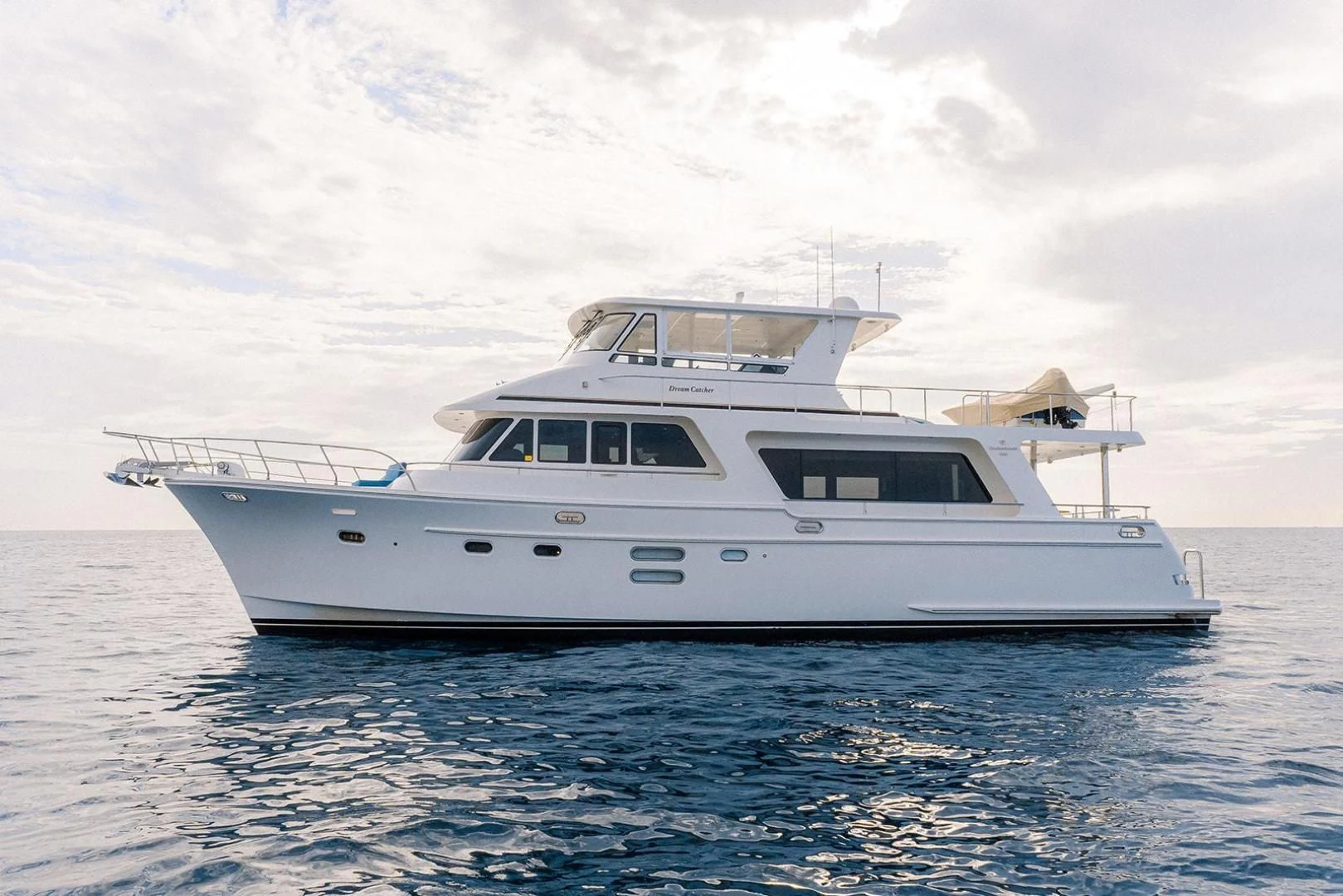 a white yacht in the water aboard DREAM CATCHER Yacht for Sale