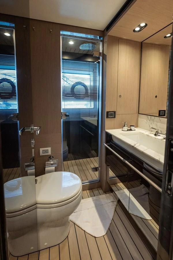a bathroom with a glass shower door aboard CLOUDY BAY Yacht for Sale