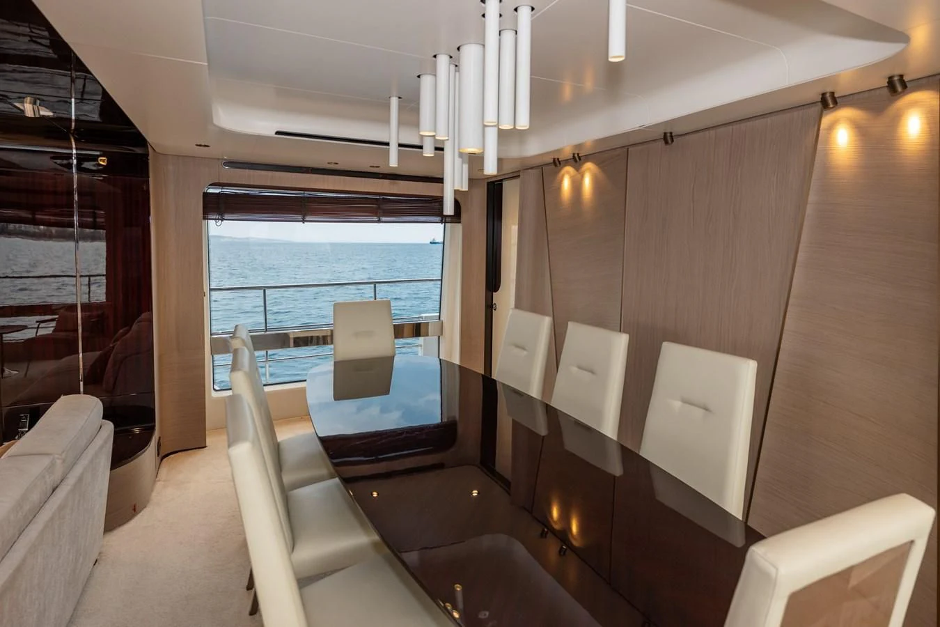 a room with a table chairs and a window aboard CLOUDY BAY Yacht for Sale