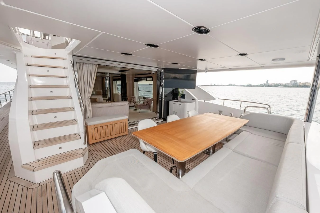 a room with a table and chairs aboard CLOUDY BAY Yacht for Sale