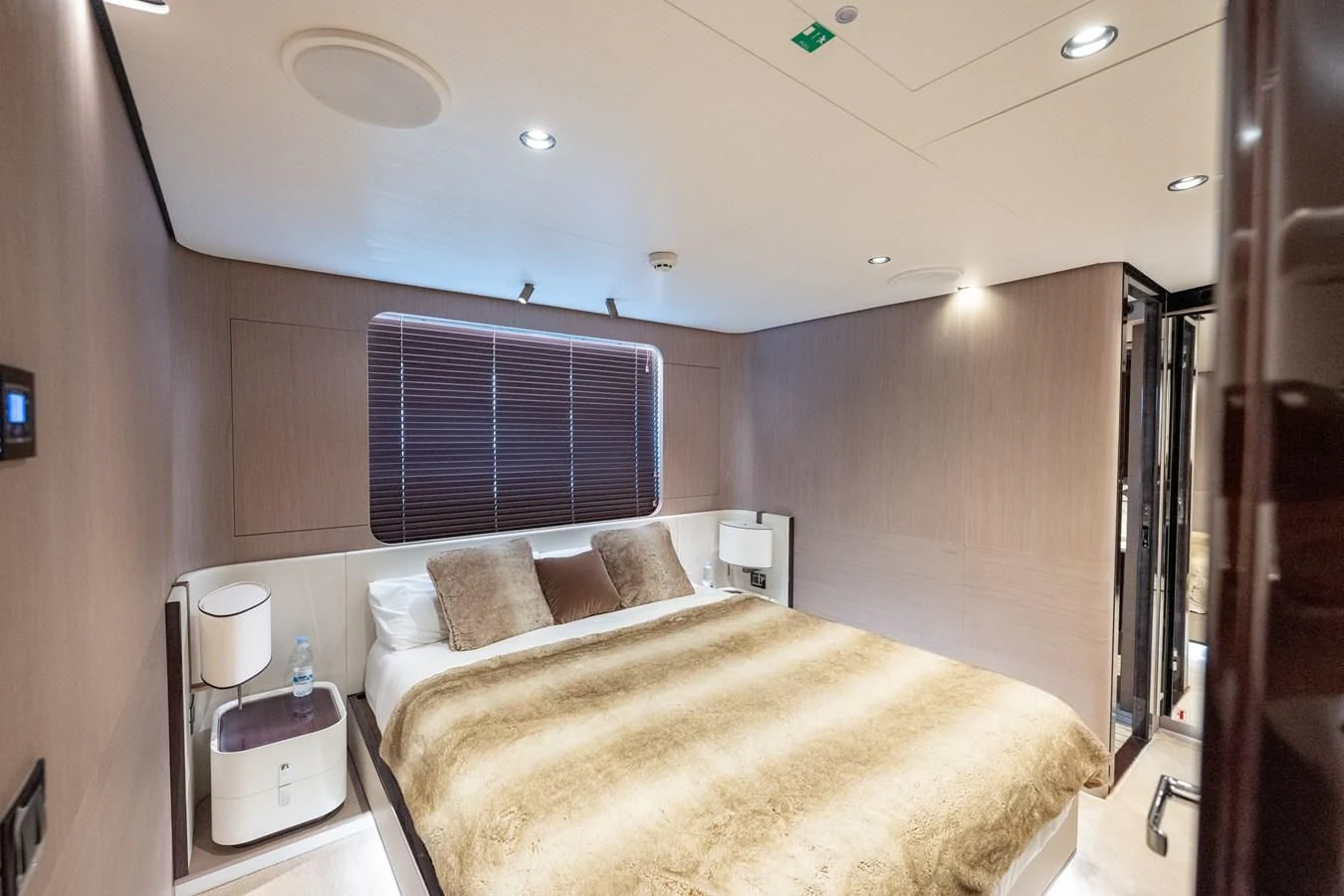 a bedroom with a bed and a window aboard CLOUDY BAY Yacht for Sale