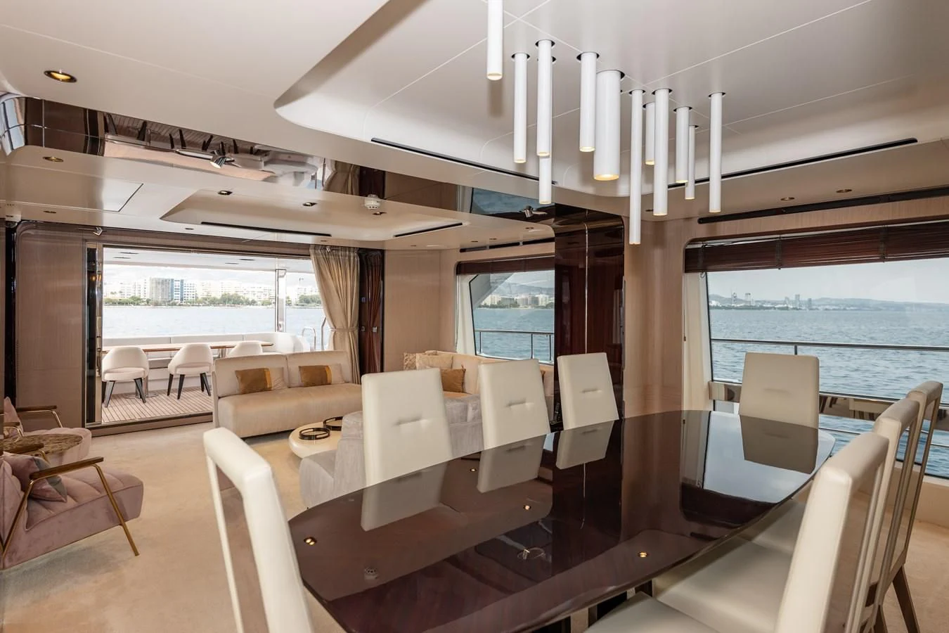 a room with tables and chairs aboard CLOUDY BAY Yacht for Sale