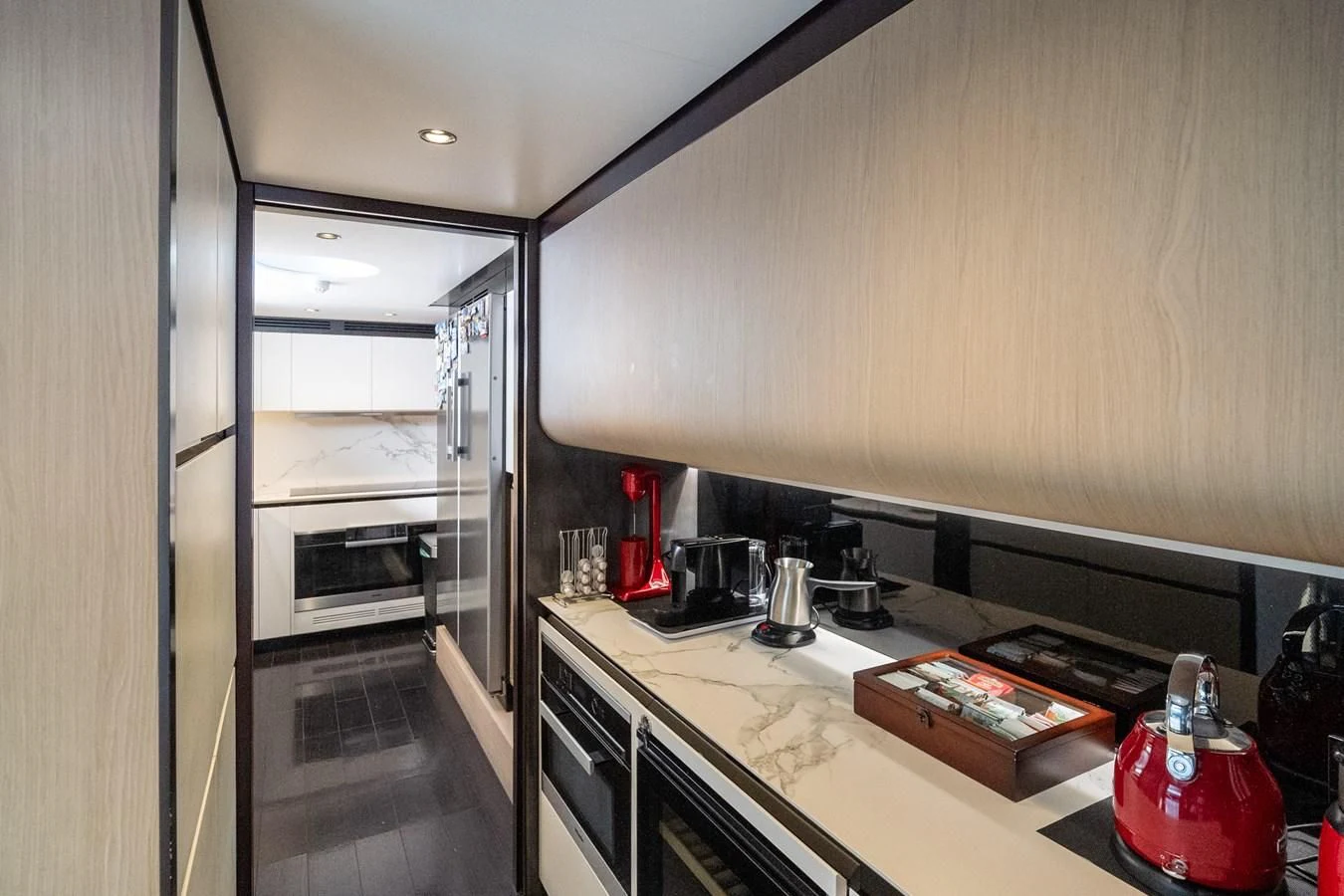 a kitchen with a red stove and a red pot on the stove aboard CLOUDY BAY Yacht for Sale