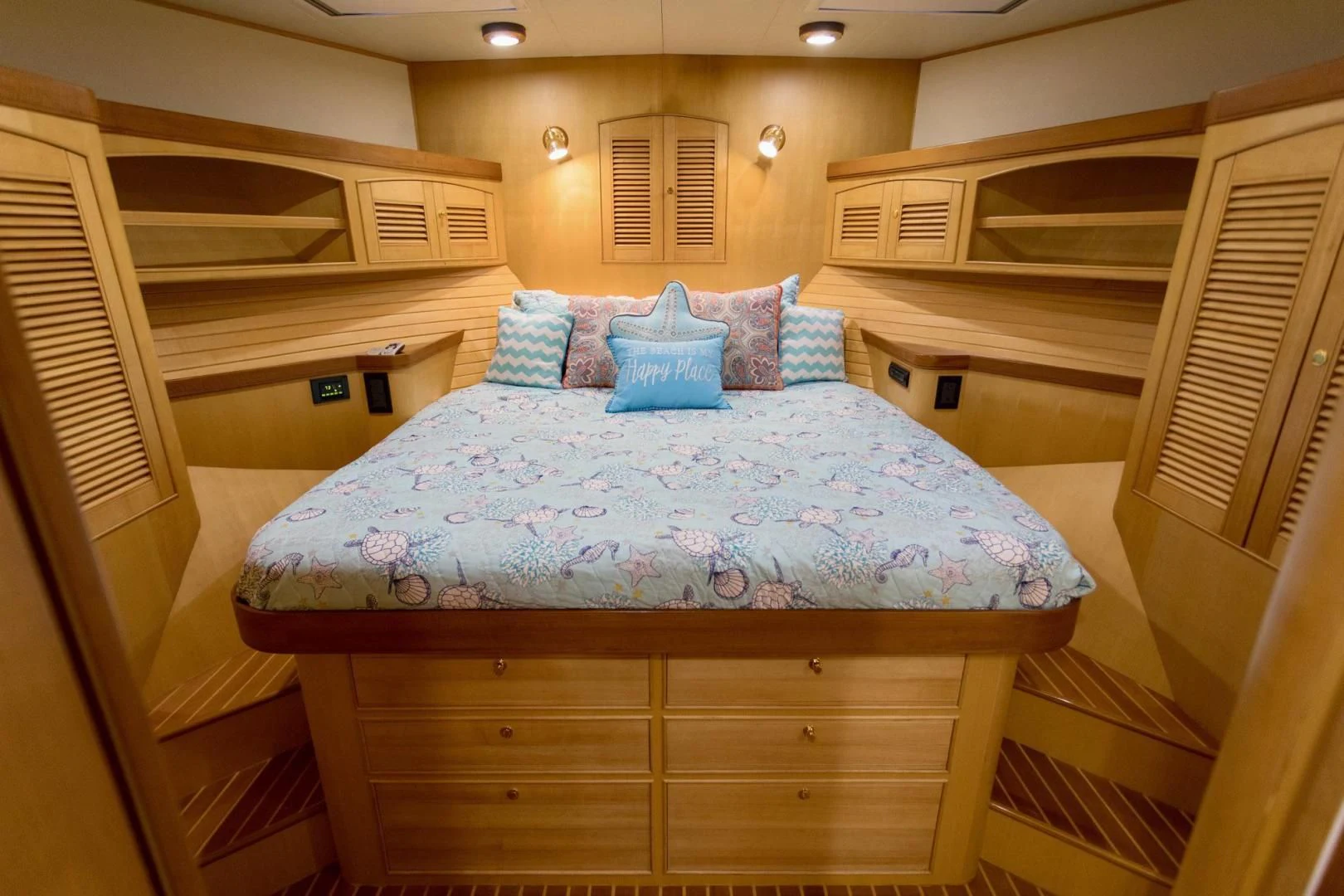a bed with blue pillows aboard SOMEDAY CAME Yacht for Sale