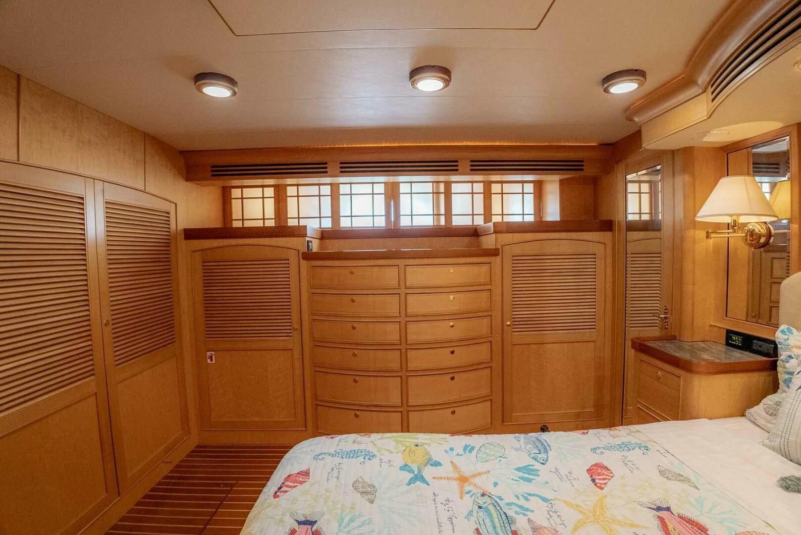 a bedroom with a bed and a dresser aboard SOMEDAY CAME Yacht for Sale
