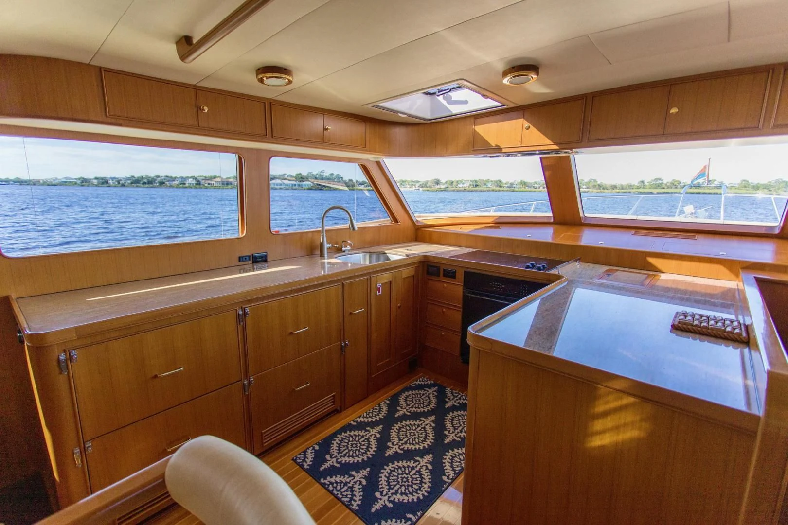 a kitchen with wooden cabinets aboard SOMEDAY CAME Yacht for Sale