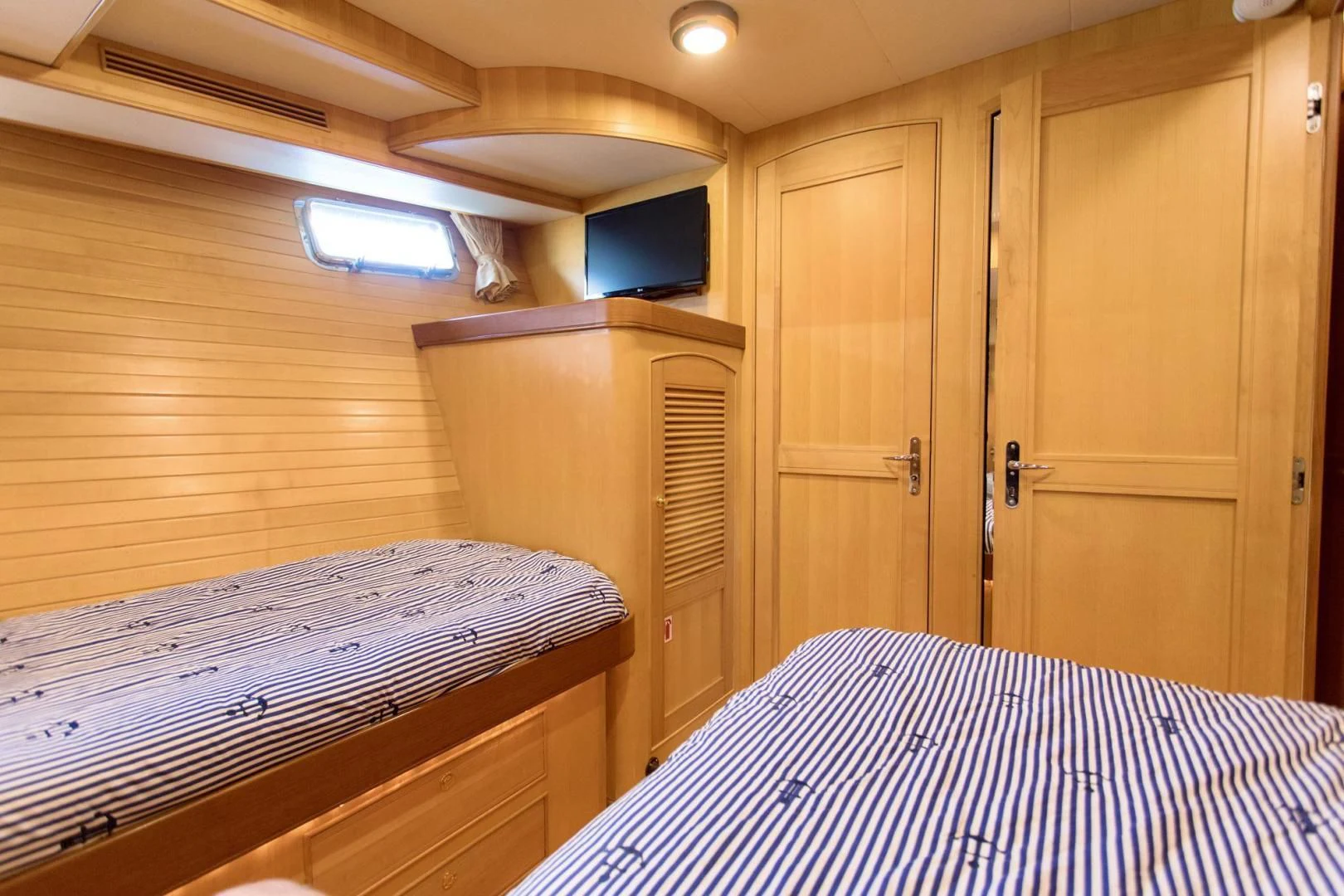 a room with a bed and a closet aboard SOMEDAY CAME Yacht for Sale