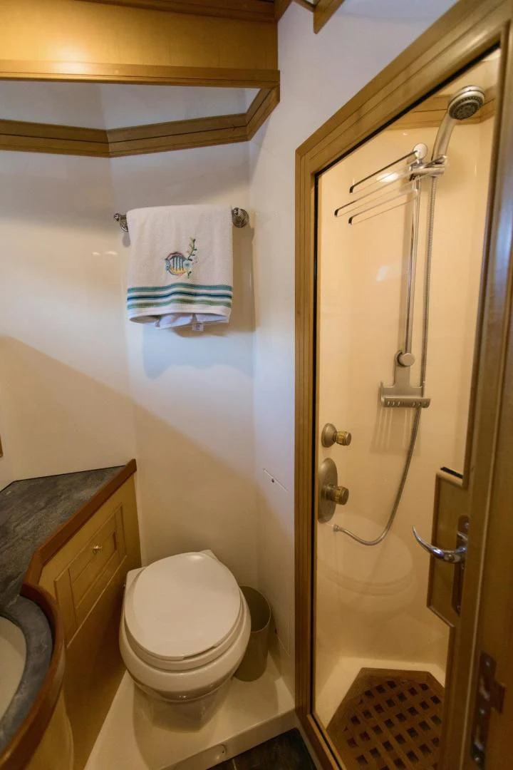 a bathroom with a toilet and a shower unit aboard SOMEDAY CAME Yacht for Sale