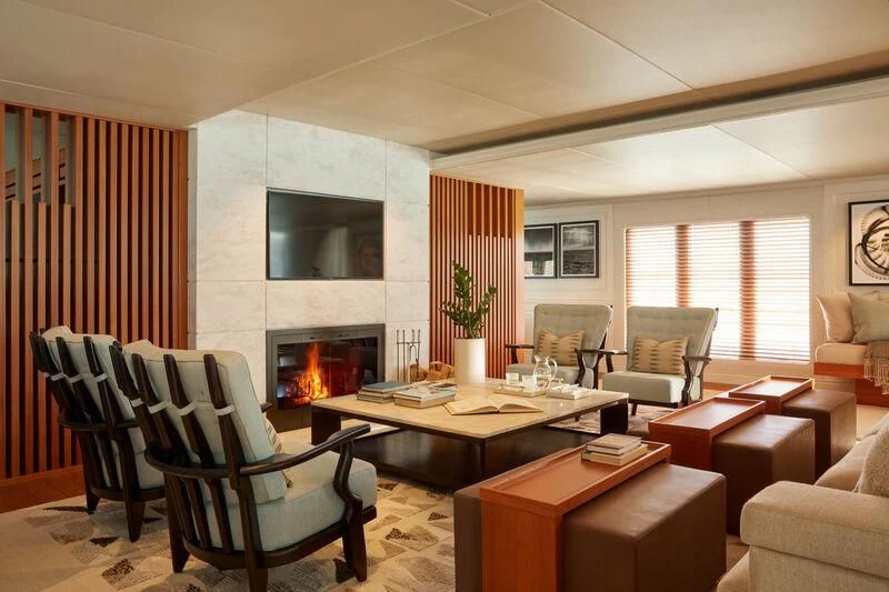 a living room with a fireplace aboard JUST B Yacht for Sale