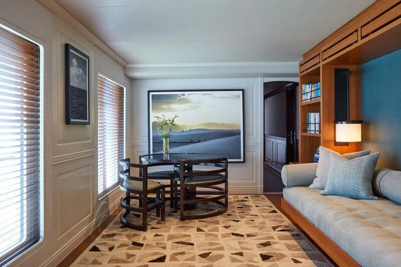 a living room with a tv and couches aboard JUST B Yacht for Sale