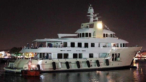 a large white boat with people on it at night aboard E&E Yacht for Sale