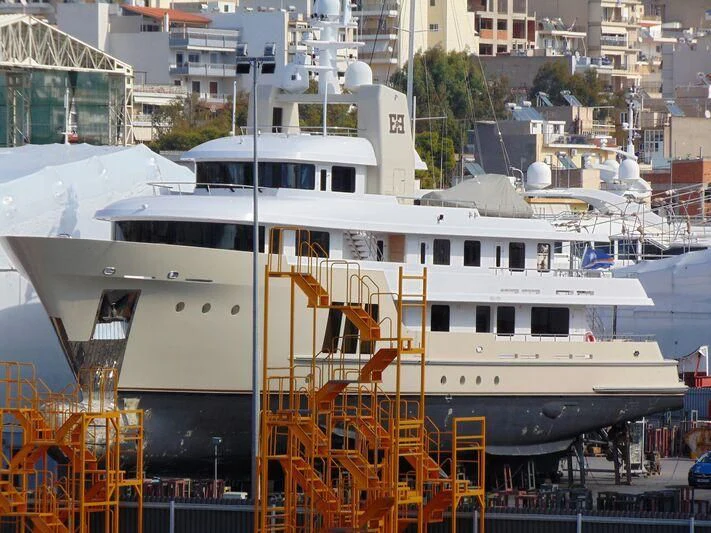 a large white boat in a harbor aboard E&E Yacht for Sale