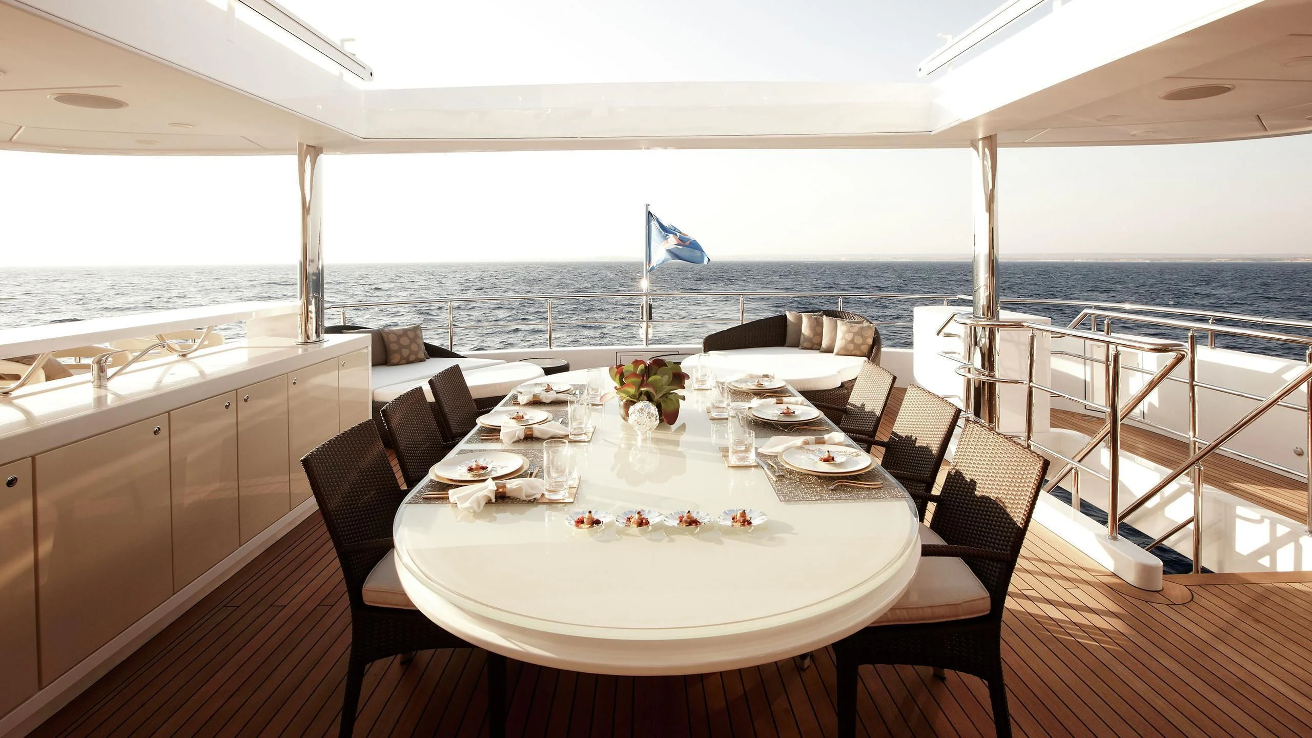 a table set for a meal on a deck overlooking the ocean aboard E&E Yacht for Sale