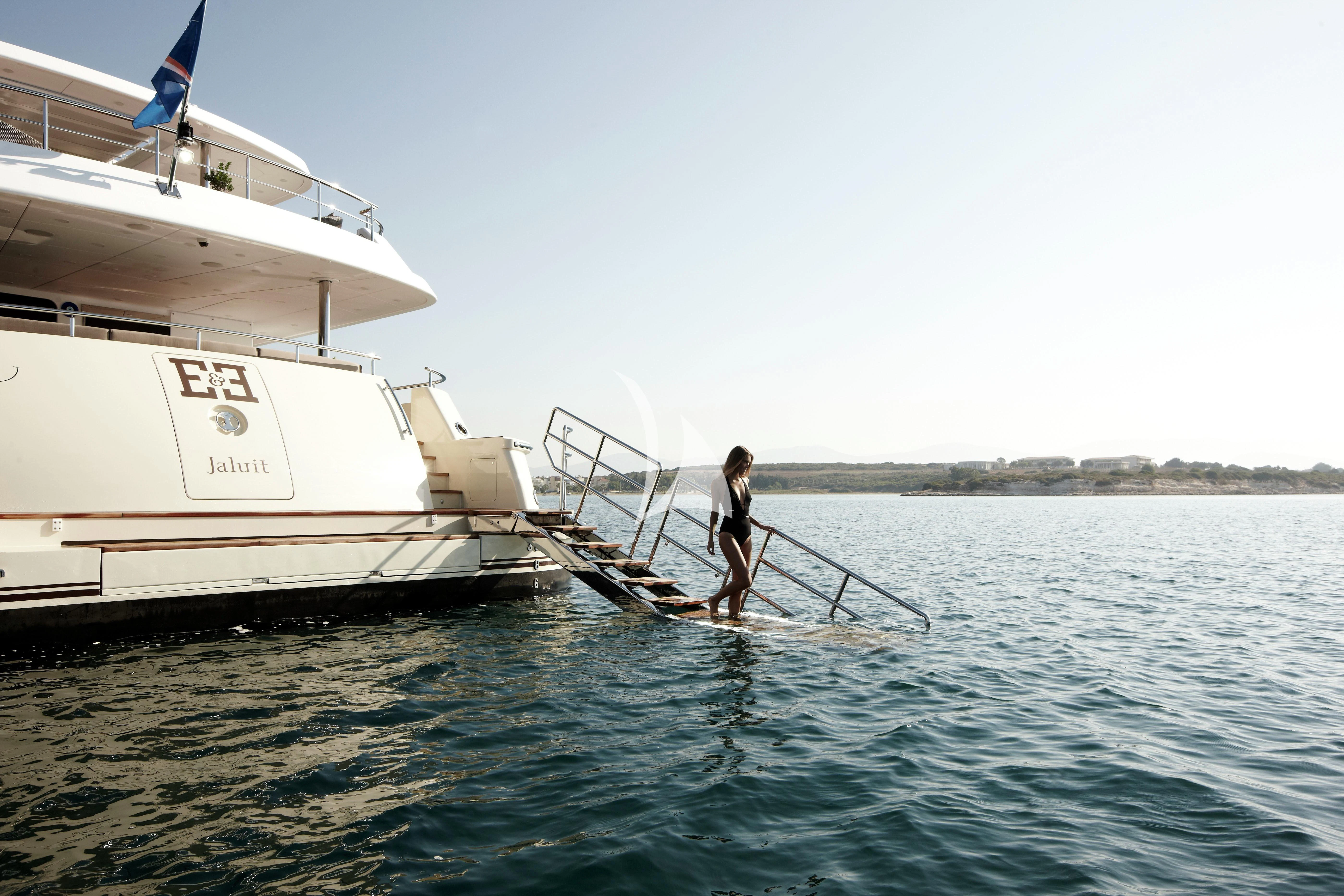 a man standing on a boat in the water aboard E&E Yacht for Sale