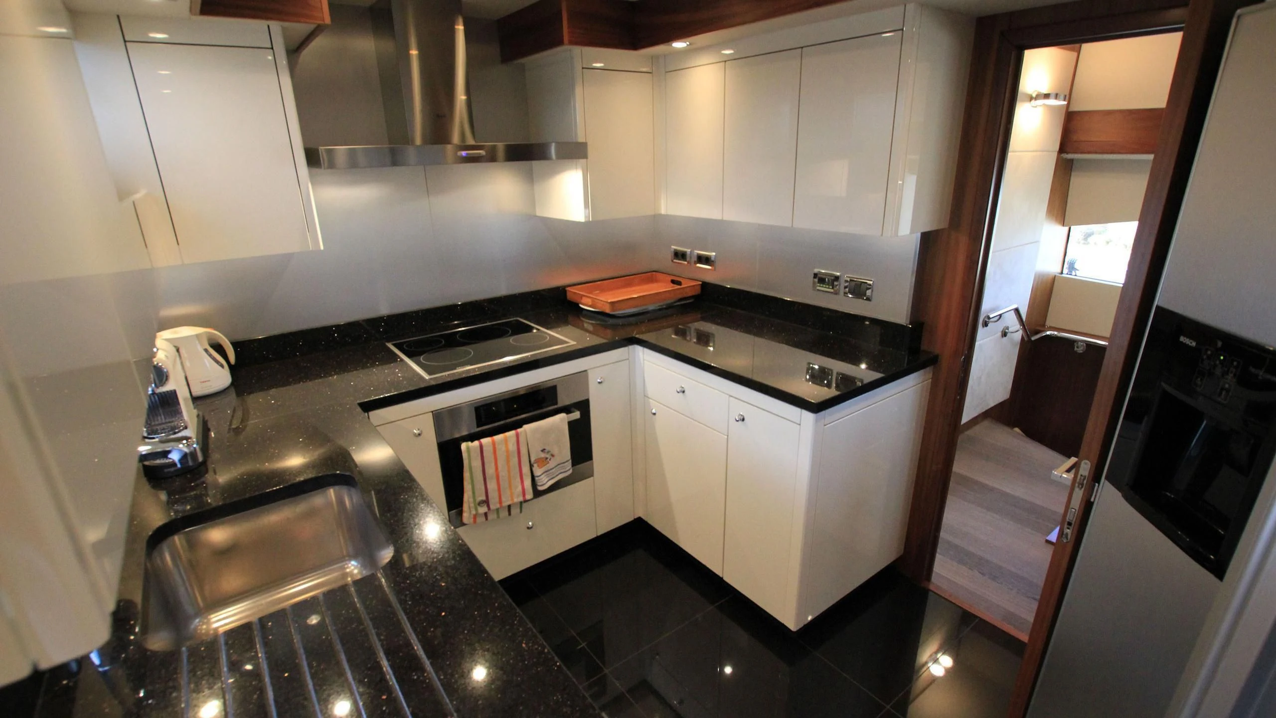 a kitchen with white cabinets aboard E&E Yacht for Sale