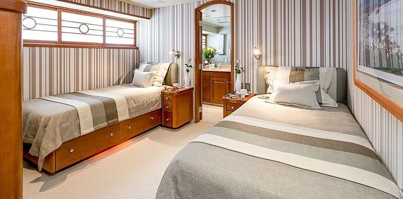 a couple of beds in a room aboard DAYDREAM Yacht for Sale
