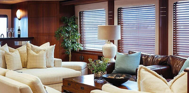 a living room with a couch and a plant aboard DAYDREAM Yacht for Sale