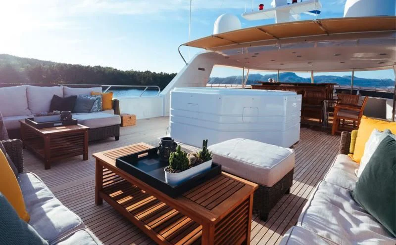 a living room with a couch and a table aboard DAYDREAM Yacht for Sale