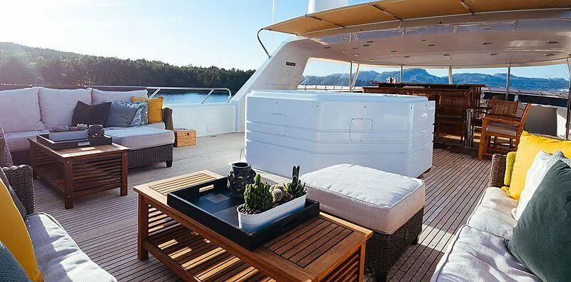 a living room with a large white couch and a table aboard DAYDREAM Yacht for Sale