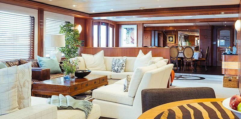 a living room with a couch and a table aboard DAYDREAM Yacht for Sale