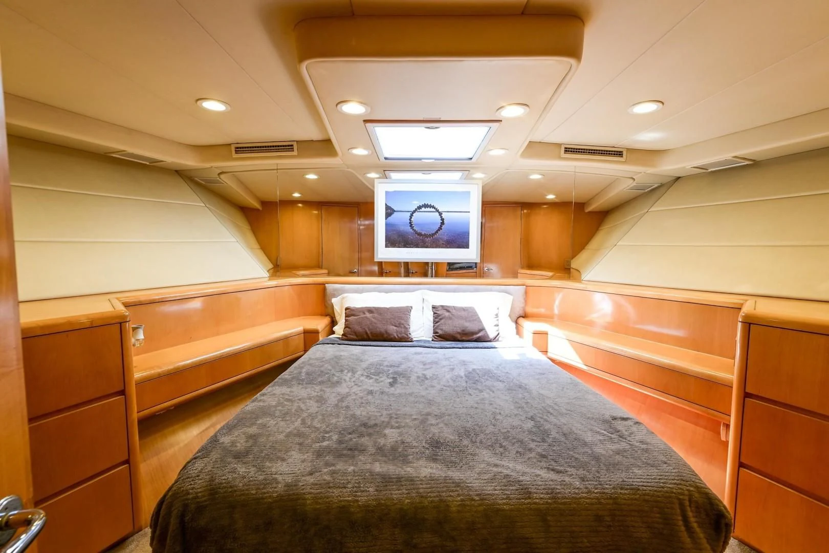 a room with a bed and a television aboard MAHA Yacht for Sale