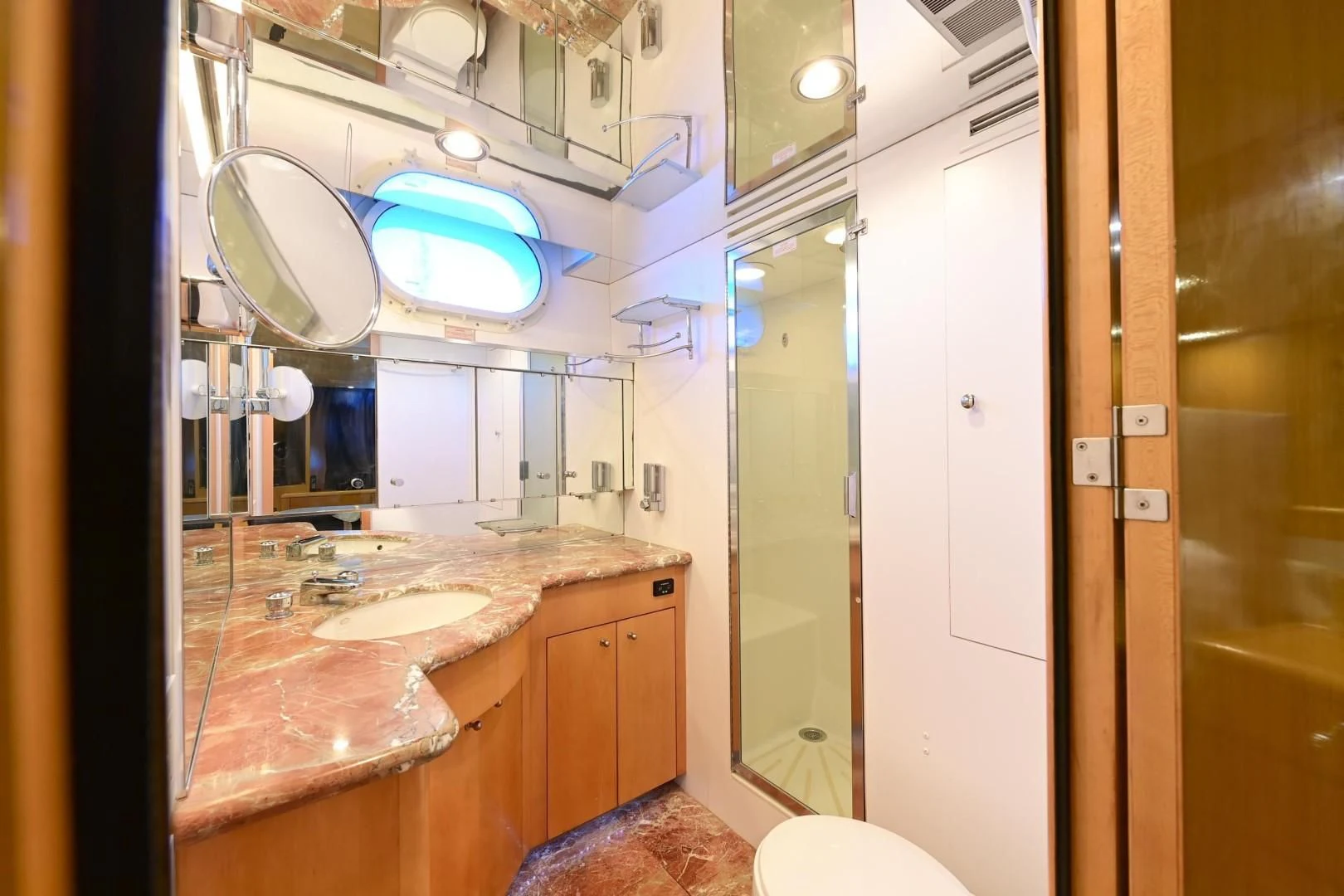 a bathroom with a countertop sink and mirrors aboard MAHA Yacht for Sale