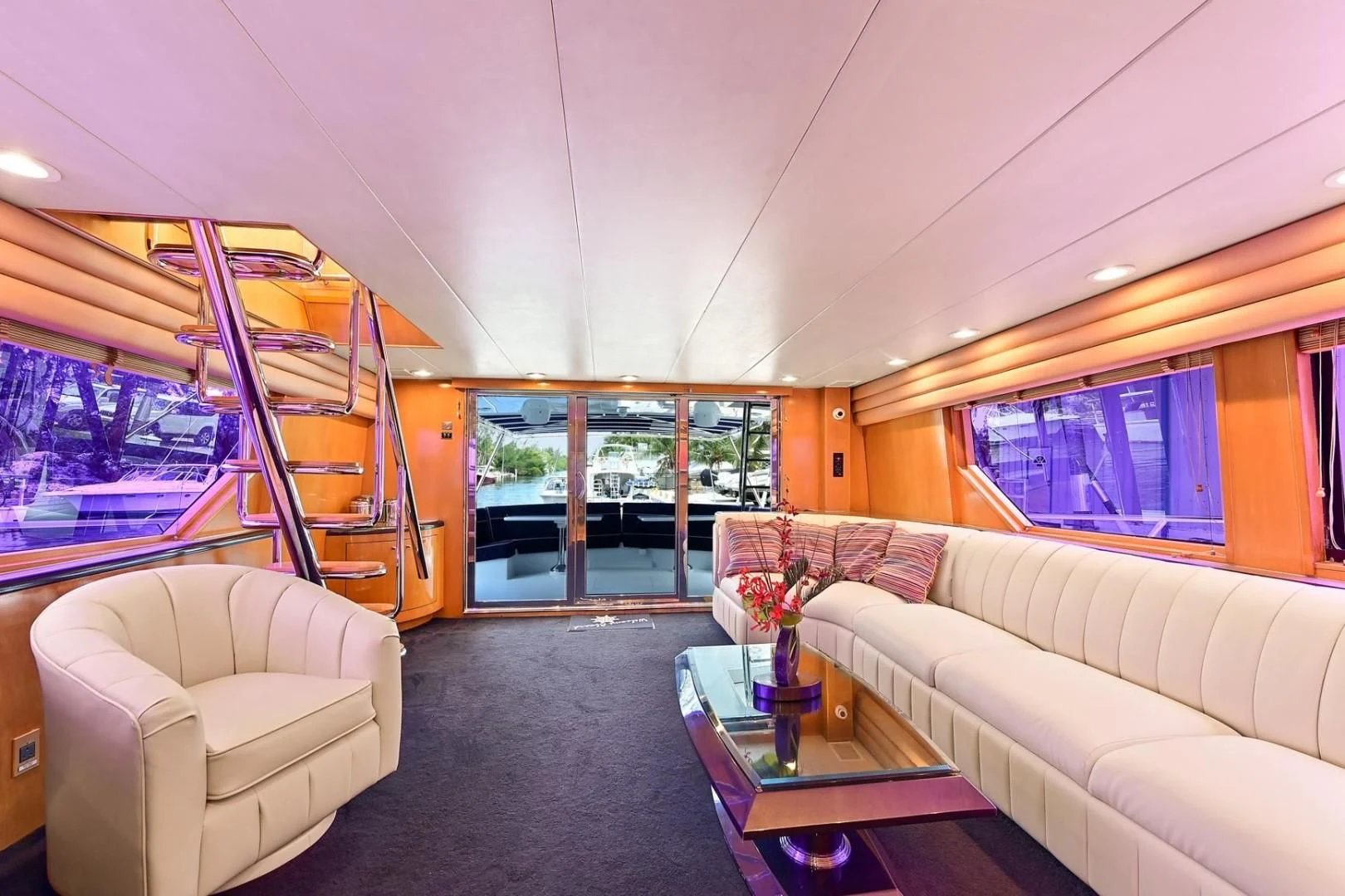 a living room with a staircase aboard MAHA Yacht for Sale