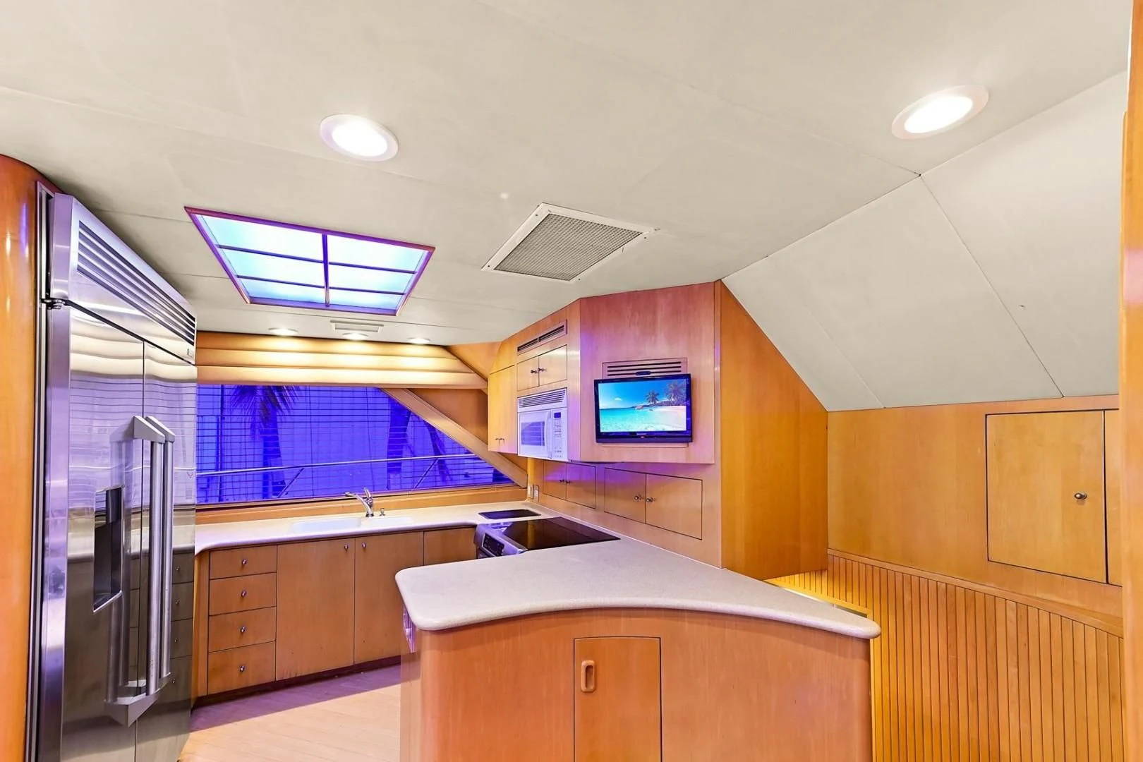 a room with a tv and a fridge aboard MAHA Yacht for Sale