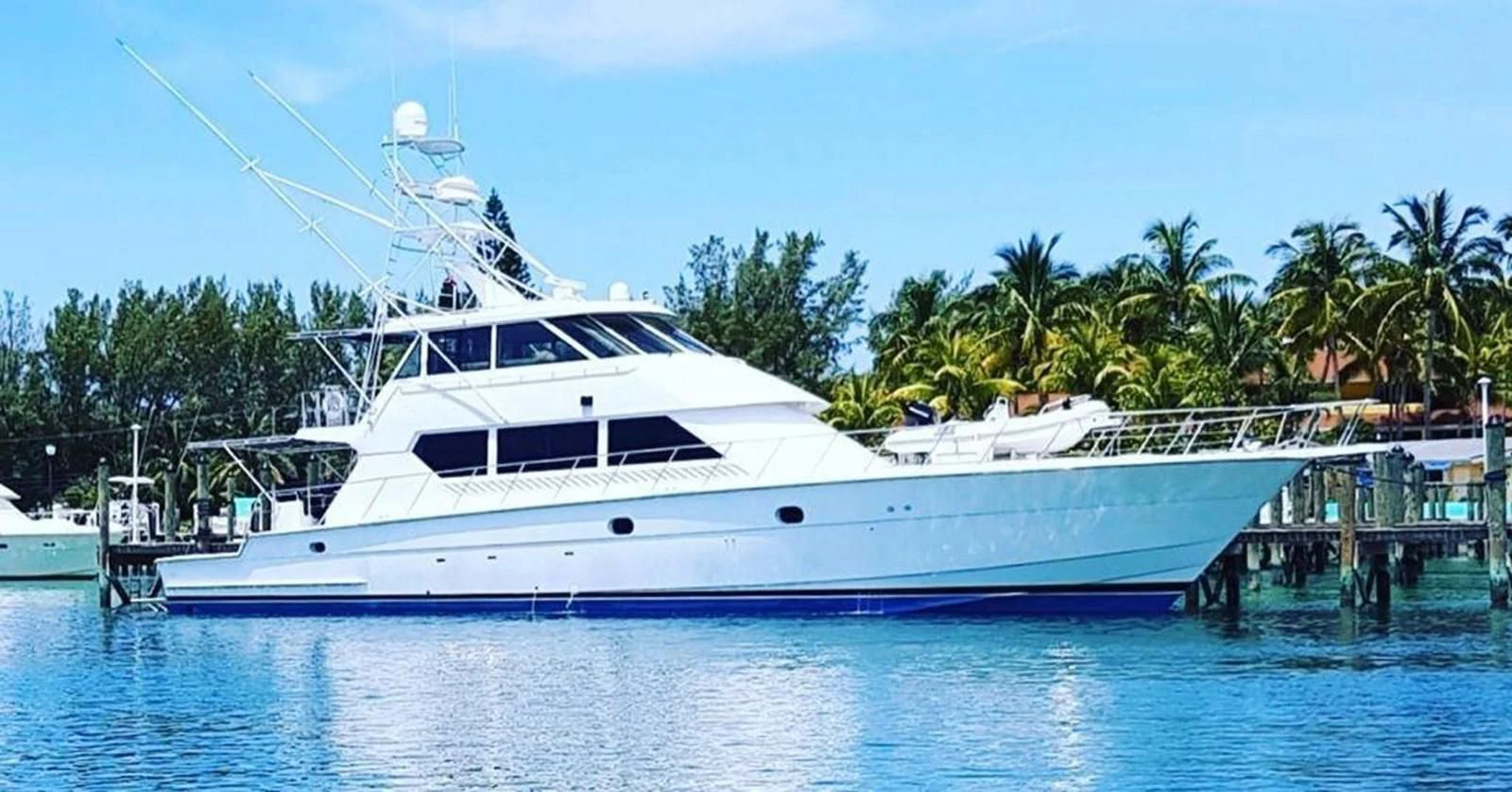 a large white boat docked at a pier aboard MAHA Yacht for Sale